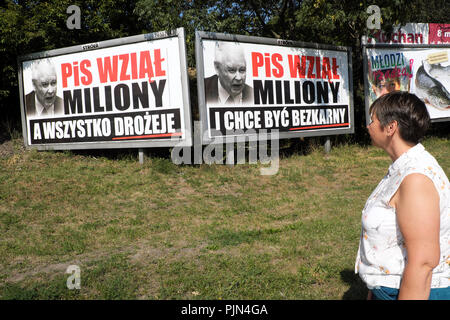 Warsaw Poland a woman walks past political billboard posters showing anti government anti PiS party slogans August 2018 Stock Photo