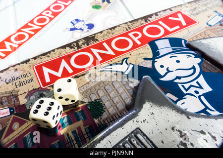 Monopoly Board Game close up with the box, board and dices. The classic real estate trading game from Parker Brothers Stock Photo
