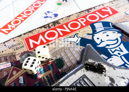 Monopoly Board Game close up with the box, board and dices. The classic real estate trading game from Parker Brothers Stock Photo