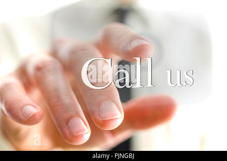 Detail of businessman finger pushing Call us button on a virtual screen. Stock Photo