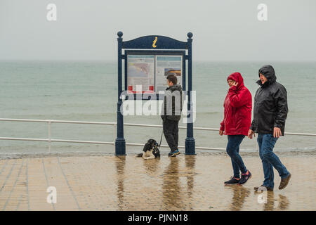 Aberystwyth Wales UK, Saturday 08 September 2018  UK Weather: People walking  under their umbrellas and wrapped up against the elements on a grey wet and dismal morning at the seaside in Aberystwyth, on the Cardigan Bay coast of West Wales   Photo © Keith Morris / Alamy Live News Stock Photo