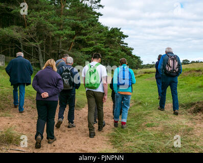 John Muir Country Park, Dunbar, East Lothian, Scotland, UK, 8th September 2018. A small group of people enjoy a walk and talk by David Connelly of East Lothian Council Archaeology Service examining evidence of an 8000 year old tsunami, a rediscovered Neolithic agricultural settlement and World War defensive locations during East Lothian Archaeology and Local History Fortnight which takes takes place in September each year, and is part of the annual Scottish Archaeology month. A range of walks, talks and demonstrations take place across East Lothian during the two week period Stock Photo