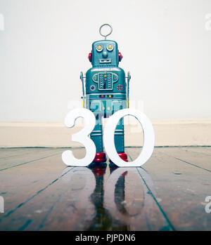 robot and the number 30 on a old wooden floor with reflection Stock Photo
