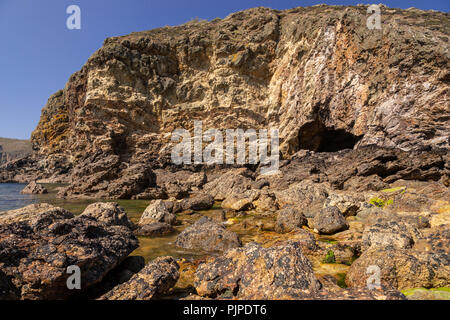 Cliffs and cave at Ynys-y-Fydlyn on the coast of Anglesey, North Wales Stock Photo