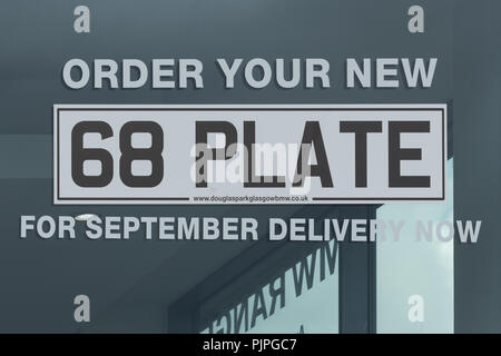 68 new car number plate advertising at car dealership uk Stock Photo