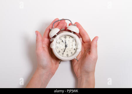 Hands holding alarm clock view from flatlay Stock Photo