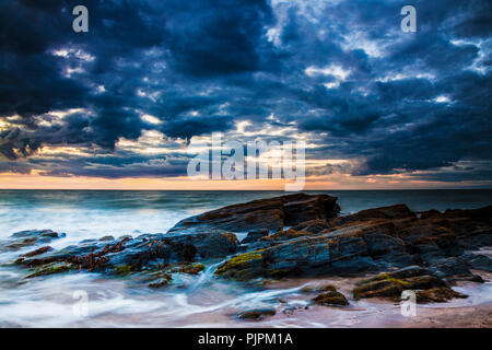 Sunset over the beach at Tresaith in Ceredigion, Wales. Stock Photo