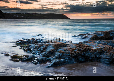 Sunset over the beach at Tresaith in Ceredigion, Wales, looking towards Aberporth. Stock Photo