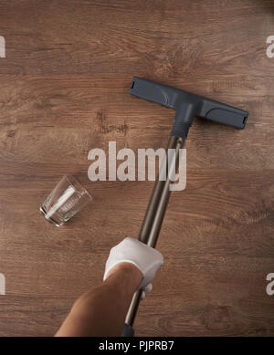 House cleaning concept. Removing dust from wooden floor above top view Stock Photo