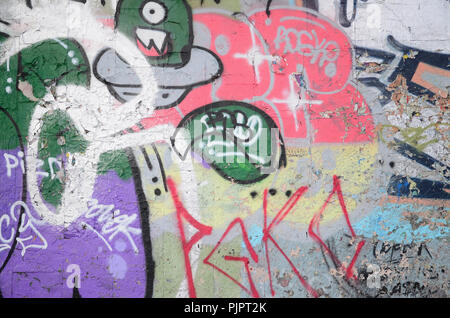 A fragment of graffiti drawing using contours, applied to the wall with the help of cans with aerosol paints over the colored filling areas. Backgroun Stock Photo