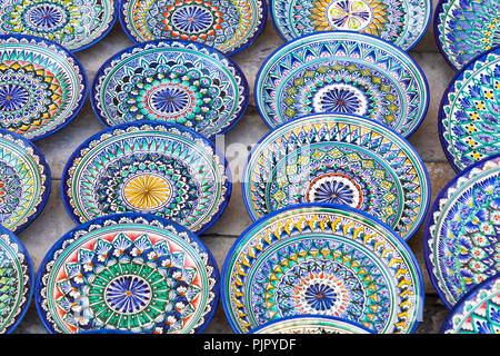 Plates and pots on a street market in the city of Bukhara, Uzbekistan.Traditional souvenir. Stock Photo