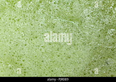 organic texture of vegetable smoothie or green natural background with froth and bubbles Stock Photo