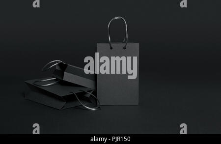Black shopping bags on black background Stock Photo