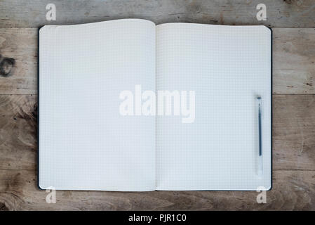 blank pages of open diary or notepad on rustic wooden table Stock Photo