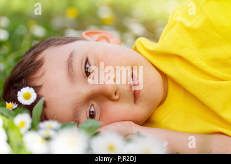 Child kid spring flower meadow flowers little boy day dreaming outdoor outdoors outside nature field Stock Photo