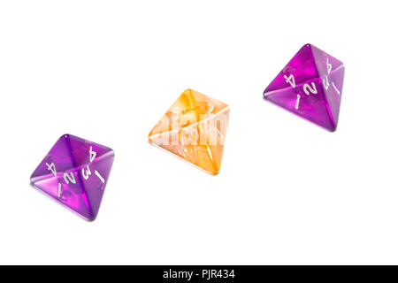 Four Sided Dices (d4) translucent in purple and orange. Stock Photo
