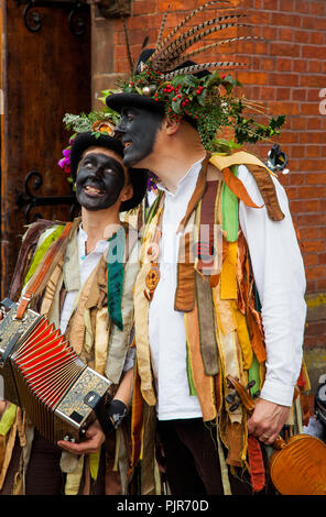 Morris men and dancers performing and playing instruments outside at the Cheshire market town of Sandbach Cheshire England UK Stock Photo