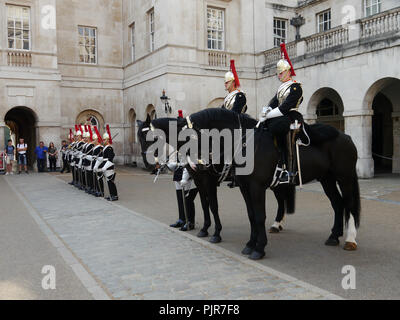 The Quens lifeguards (Blues and Royals) take part in the dismounting ceremony at  Horse Guards Parade, London Stock Photo