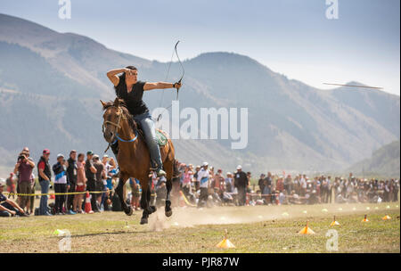Issyk-Kul, Kyrgyzstan, 6th September 2018: american woman competing in archery on horseback game Stock Photo