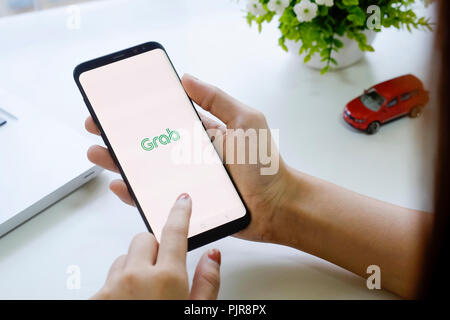 CHIANG MAI,THAILAND - FEB 19, 2018 : Samsung galaxy S8 Plus open grab application on woman hands,Grab taxi Many Thailand people are attracted to join  Stock Photo