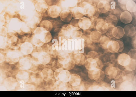 Chaotic motion of numerous defocused light spots. Sunlight is reflected in the waves. Unusual water color in retro style with a light vignette at the  Stock Photo