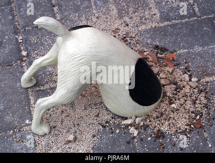 Funny figurine of digging dog Stock Photo