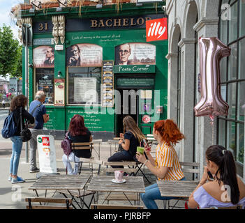 Readers of the literary content by writers and poets on the face of the Bachelor Inn on Bachelors Walk Quay by the River Liffey in Dublin Ireland Stock Photo