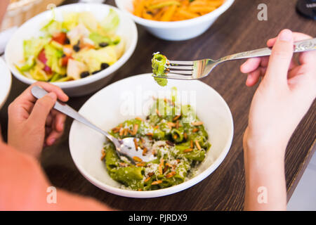 Female eating pasta in the restaurant close up Stock Photo