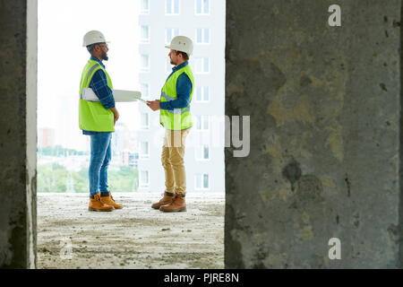 Construction engineers working on apartment building Stock Photo