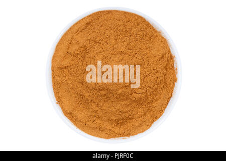 Cinnamon spice powder from above bowl isolated on a white background Stock Photo