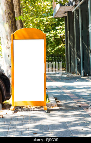 Billboard on the Street Rectangular White Vertical Mockup City Advertisement. Stock Photo