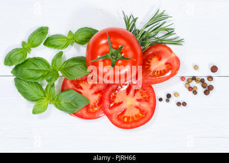 Tomatoes tomatos vegetables with basil from above wooden board wood Stock Photo