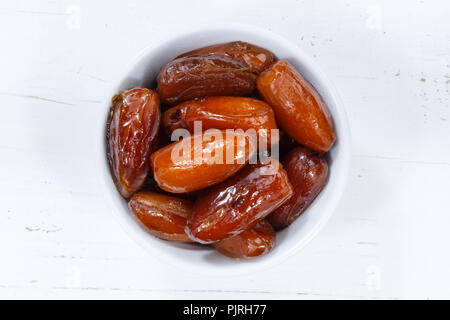 Dates fruit date from above bowl wooden board wood Stock Photo