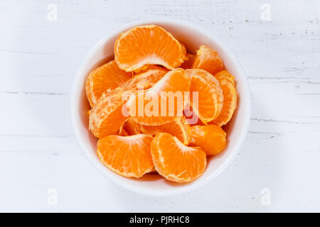 Mandarin oranges fruits from above bowl wooden board wood Stock Photo