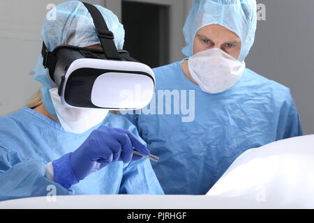 Two Doctors in Operating room surgery with virtual reality Stock Photo