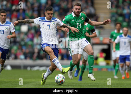 Bosnia and Herzegovina's Muhamed Besic (left) and Northern Ireland's Stuart Dallas battle for the ball during the UEFA Nations League, League B Group Three match at Windsor Park, Belfast. Stock Photo