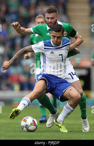 Bosnia and Herzegovina's Muhamed Besic (left) and Northern Ireland's Stuart Dallas battle for the ball during the UEFA Nations League, League B Group Three match at Windsor Park, Belfast. Stock Photo