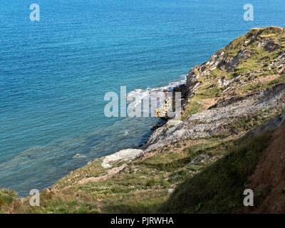 The more resitant rocks do not get eroded so quickly and form a slab or wave cut platform at the base of cliffs in the tidal zone, Stock Photo