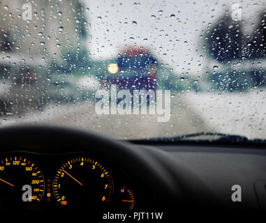 dashboard and rain droplets on car windshield Stock Photo
