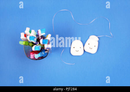 Toothbrushes and dental floss on blue background, top view Stock Photo