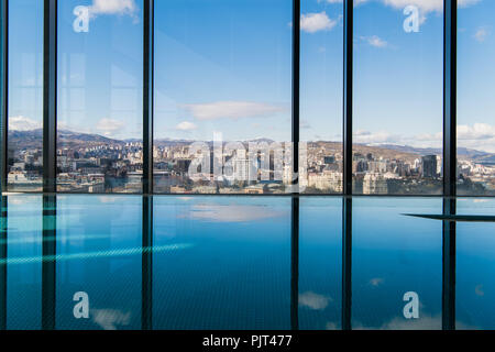 Contemporary interior with swimming pool and city view. Great water surface Stock Photo
