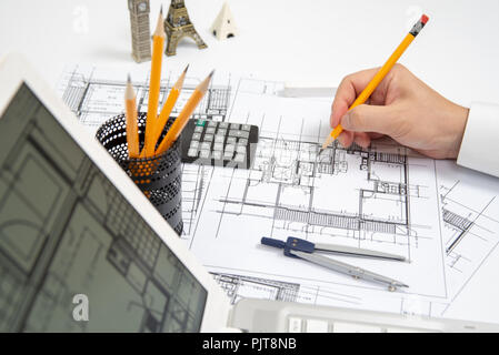 The hand of a male architect drawing a design using a pencil. Stock Photo