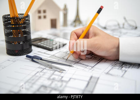 The hand of a male architect drawing a design using a pencil. Stock Photo