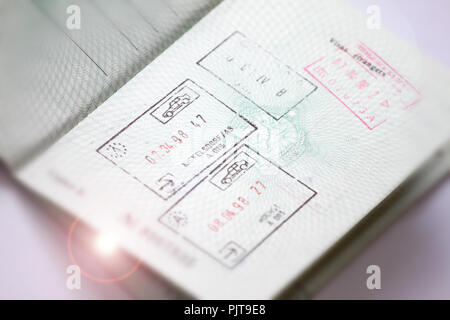 Customs stamps in international passport for traveling around the World. Document for traveling. Stamps and visas. Stock Photo