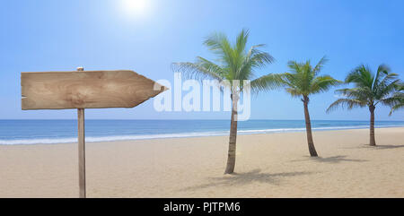 Beach with palm trees, blue sky and wooden sign