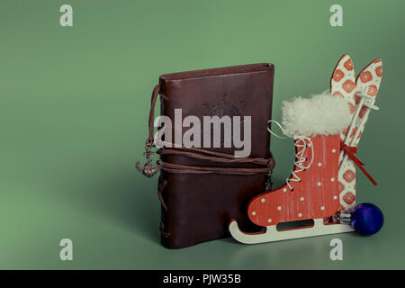 leather vintage notebook with entourage for Christmas. skiing skates. Stock Photo