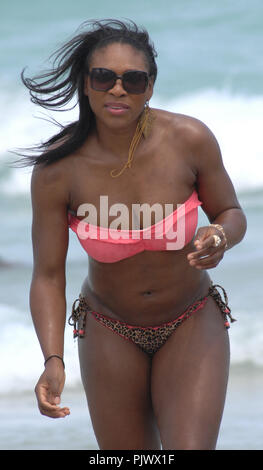 MIAMI BEACH, FL - APRIL 16:  Tennis great Serena Williams took a break from her rehab efforts with a day at the beach.  The 29-year-old hit Sobe with friends and ate some lunch on the beach before  taking a dip in the ocean wearing a two piece swimsuit with a pink top and leopard print bottom.  on April 16, 2011 in Miami Beach, Florida.   People:   Serena Williams Stock Photo