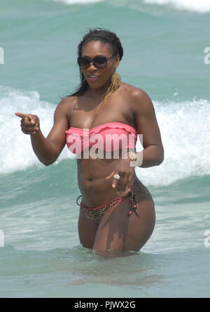 MIAMI BEACH, FL - APRIL 16:  Tennis great Serena Williams took a break from her rehab efforts with a day at the beach.  The 29-year-old hit Sobe with friends and ate some lunch on the beach before  taking a dip in the ocean wearing a two piece swimsuit with a pink top and leopard print bottom.  on April 16, 2011 in Miami Beach, Florida.   People:   Serena Williams Stock Photo