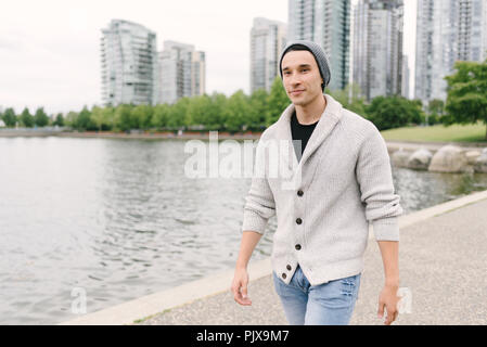 Young man walking along seawall, Yaletown, Vancouver, Canada Stock Photo