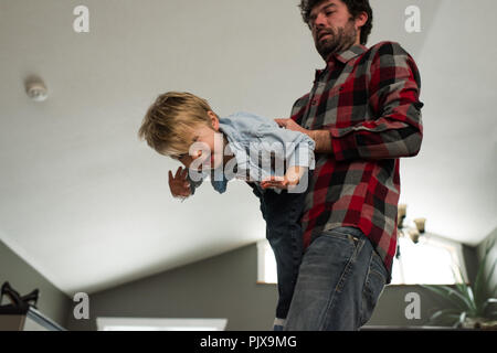 Father playing with son at home Stock Photo